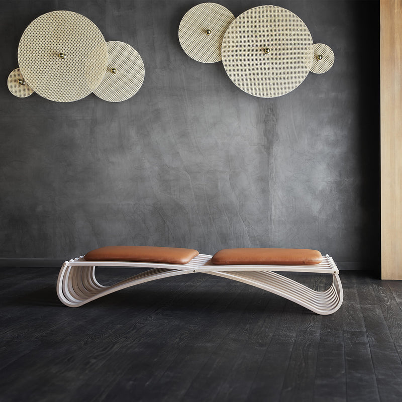 Beech wood daybed placed on a dark wooden floor