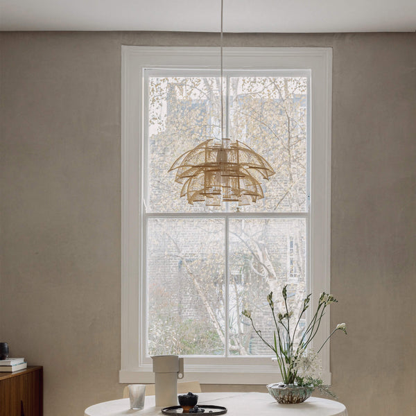 Bamboo pendant lighting placed in a dining room, by the window