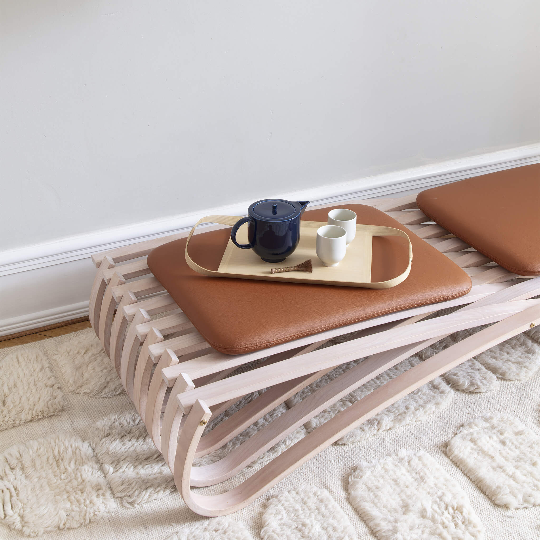 Daybed with a tea set placed on its cushions