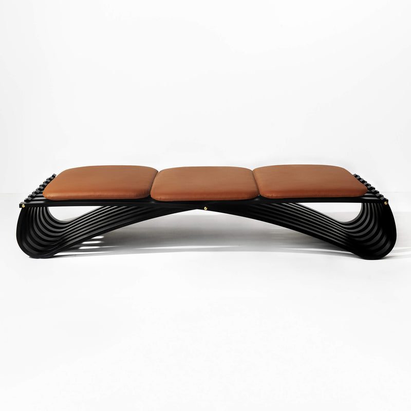 Black wooden daybed with three cognac leather cushions, front view