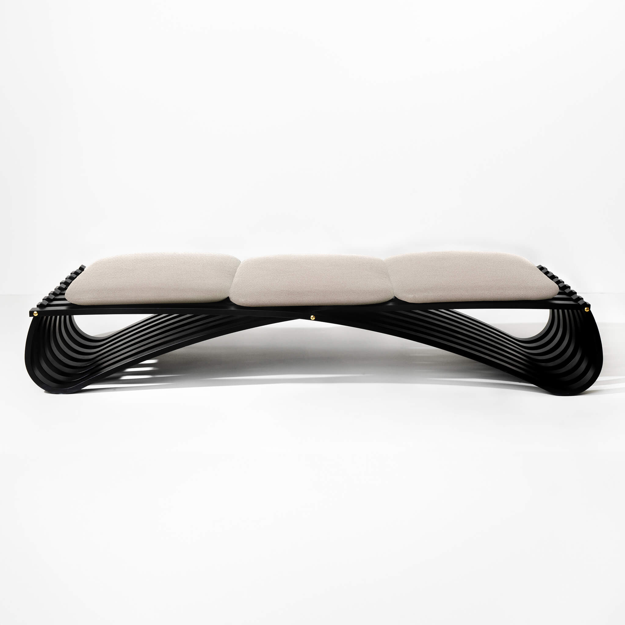 Black wooden daybed with three beige textile cushions, front view