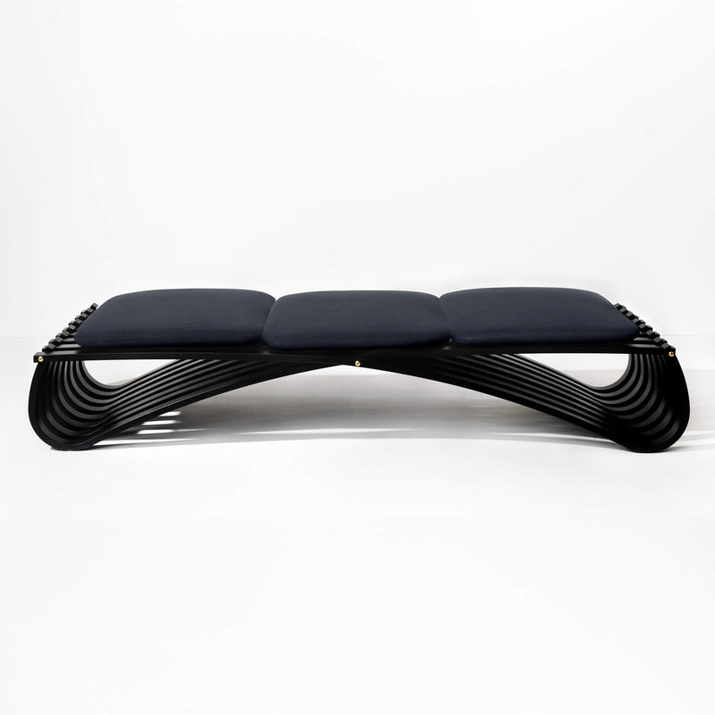 Black wooden daybed with three dark blue textile cushions, front view