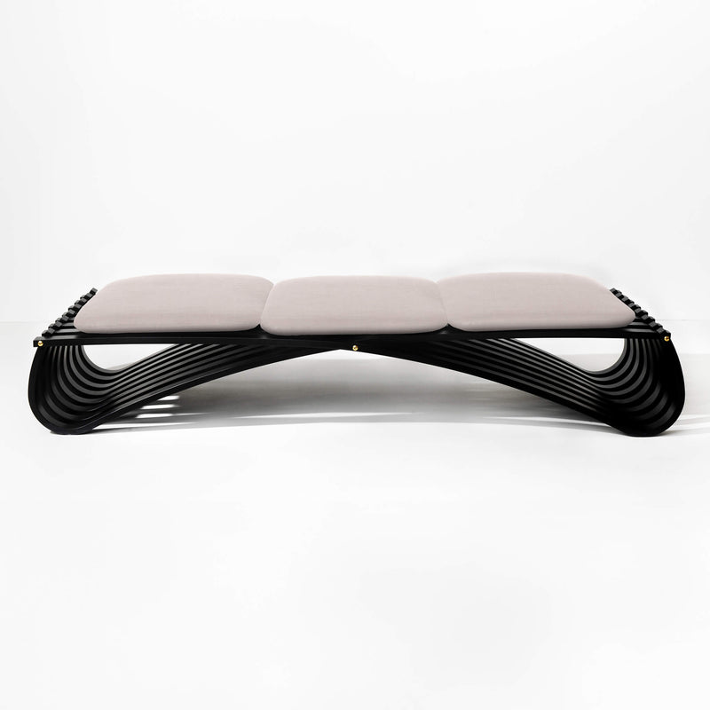 Black wooden daybed with three light rose textile cushions, front view