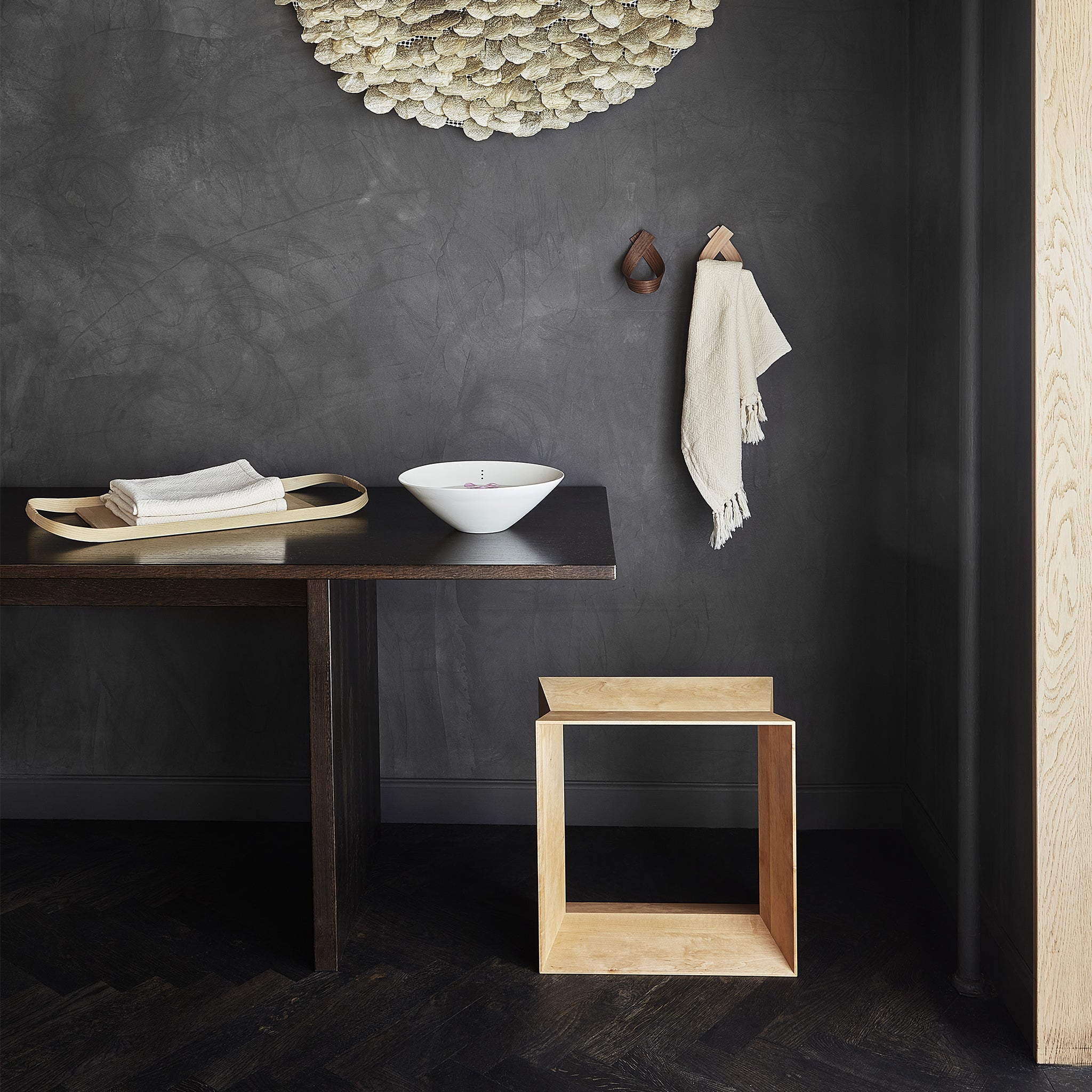 Two coat hooks attached to a wall in a kitchen area