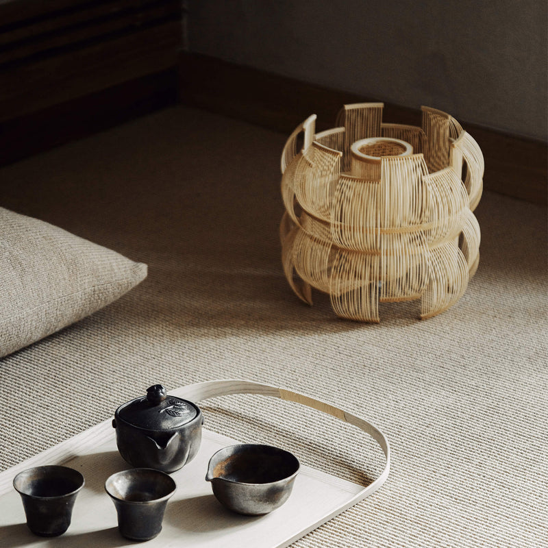 Bamboo table lamp next to a tray and tea set