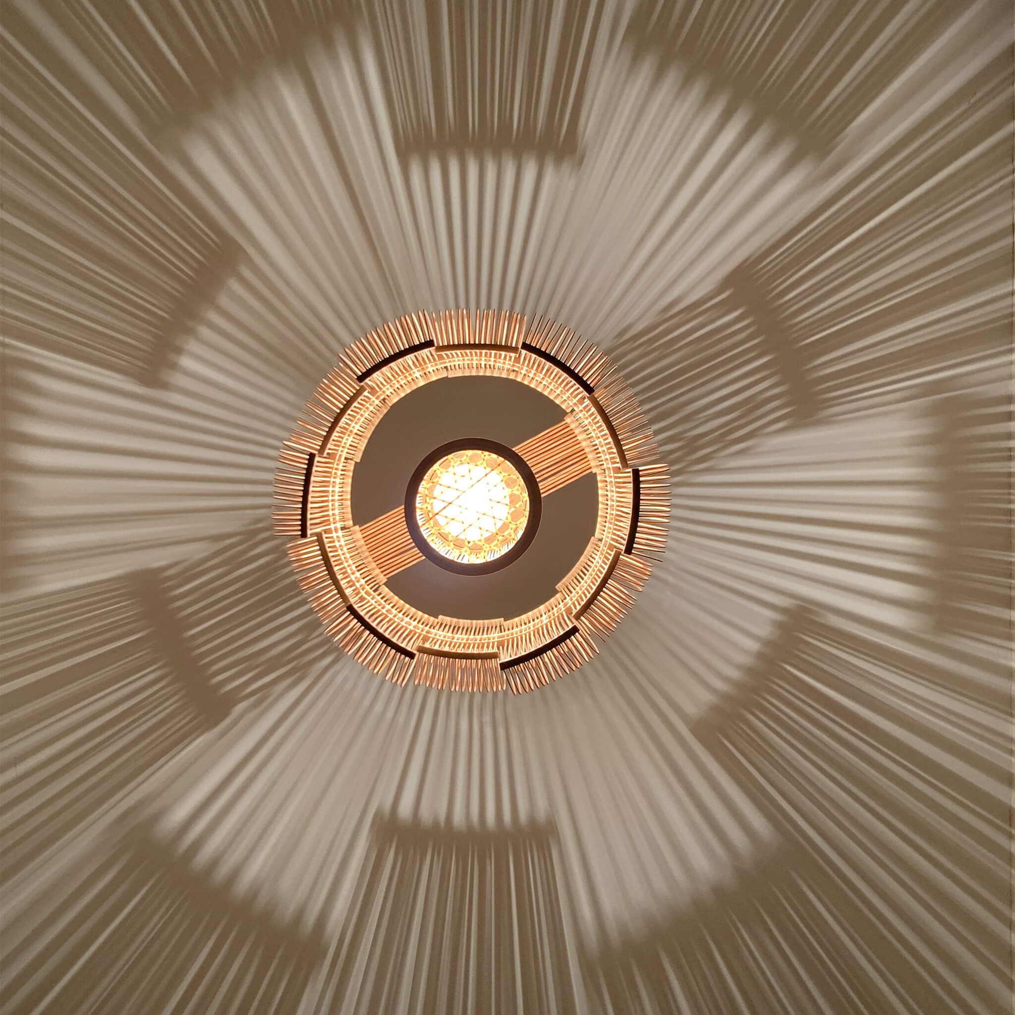 Bamboo pendant light, bottom view with the light on