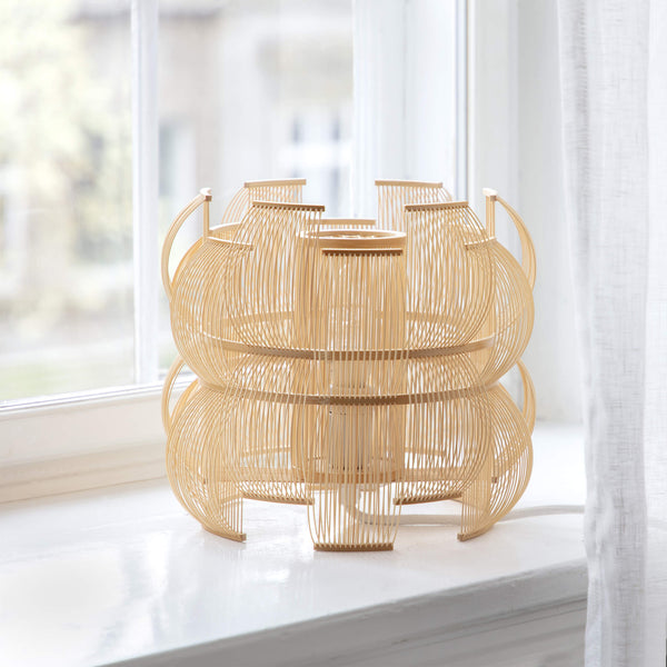 Bamboo table lamp placed by the window in daylight