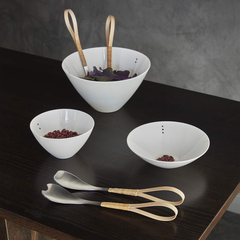 Three porcelain bowls in different shapes and sizes, each containing food