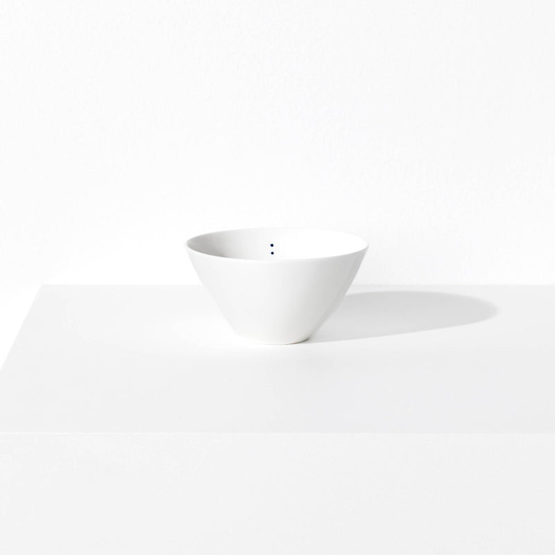 Small porcelain bowl featuring a design with two blue indigo dots