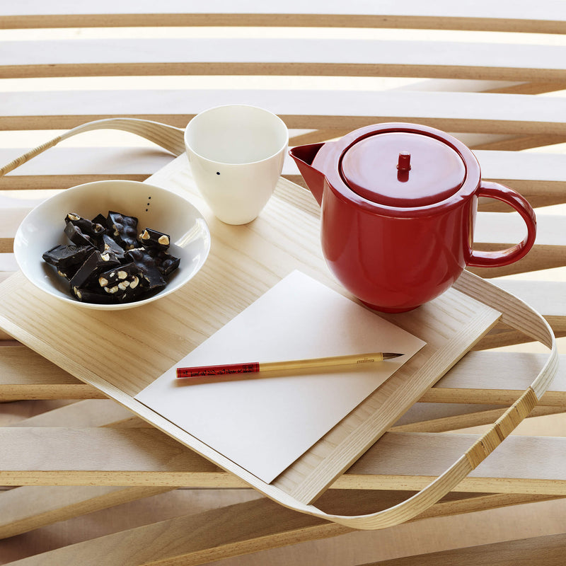 Wooden tray holding a tea pot, two bowls, pen and paper