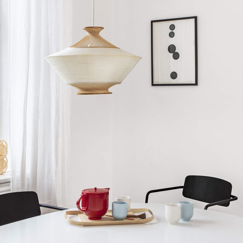 Collection featuring one teapot and four tea mugs placed on a dining table