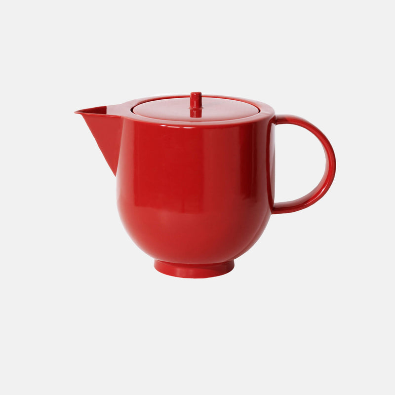 Side view of red porcelain teapot, cylindrical shape