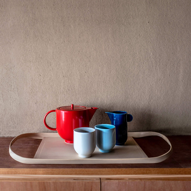 Large wooden tray holding a tea pot, pitcher and two mugs