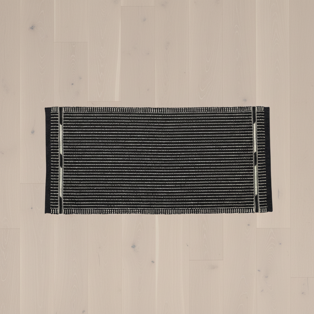 VK-3 Black Small Mat 2' x 4.25' on pale blonde oak floor - overhead view