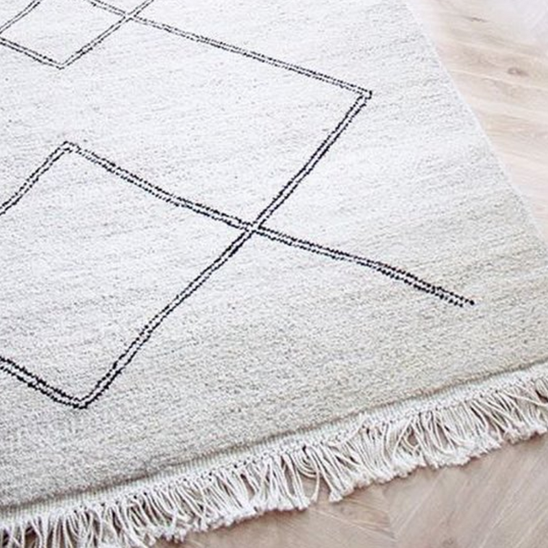 Sera Helsinki, Finnish designed hand-made rugs from Ethiopia, fair-trade, ethically made.  Available exclusively in  North America, Canada and USA, through Studio Nordhaven.  Kide - Hand Knotted - White + Black - Juuret Collection